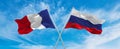 crossed national flags of France and Russia flag waving in the wind at cloudy sky. Symbolizing relationship, dialog, travelling Royalty Free Stock Photo
