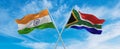 crossed national flags of India and South Africa flag waving in the wind at cloudy sky. Symbolizing relationship, dialog, Royalty Free Stock Photo
