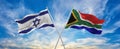 crossed national flags of Israel and South Africa flag waving in the wind at cloudy sky. Symbolizing relationship, dialog, Royalty Free Stock Photo