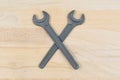 Crossed old spanners on a wooden table Royalty Free Stock Photo