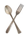 Crossed vintage spoon and fork isolated on bell background. Rustic style Royalty Free Stock Photo