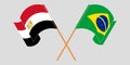 Crossed and waving flags of Egypt and Brazil
