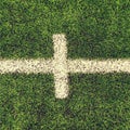 Crossed white lines on outdoor football playground. Detail of lines in a soccer field. Plastic grass and finely ground b Royalty Free Stock Photo