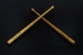 CROSSED WOOD DRUMSTICKS ON BLACK BACKGROUND Royalty Free Stock Photo