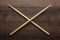 Crossed wooden drumsticks on wooden table Royalty Free Stock Photo