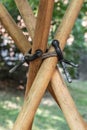 Crossed wooden poles connect together the base of the tent Royalty Free Stock Photo