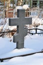 Crosses in a cemetery, monuments of the dead, a cemetery in winter, wreaths, artificial flowers. Russia