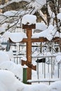 Crosses in a cemetery, monuments of the dead, a cemetery in winter, wreaths, artificial flowers. Russia