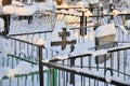 Crosses in a cemetery, monuments of the dead, a cemetery in winter, wreaths, artificial flowers. Russia Royalty Free Stock Photo