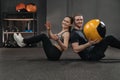 Crossfit couple exercising together with a ball Royalty Free Stock Photo