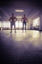 Crossfit couple facing camera with hands on hips Royalty Free Stock Photo