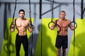 Crossfit dip ring two men workout at gym Royalty Free Stock Photo