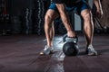 Crossfit kettlebell training in gym.