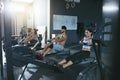 Crossfit. People Exercising On Rowing Machine In Training Gym