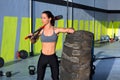 Crossfit sledge hammer woman at gym relaxed