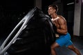 Crossfit training - man flipping tire in gym Royalty Free Stock Photo