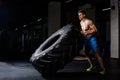 Crossfit training - man flipping tire in gym Royalty Free Stock Photo