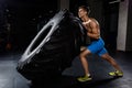 Crossfit training - man flipping tire in gym Royalty Free Stock Photo