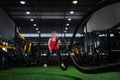 CrossFit training. View of young athletic big woman doing crossfit exercises with a rope Royalty Free Stock Photo