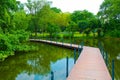 Crossing the Bridge on a Pond at Lumpini Park, Thailand. Royalty Free Stock Photo