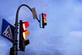 Crossing the city with a traffic light in the evening. Red and orange traffic lights Royalty Free Stock Photo