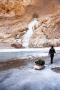 Crossing Frozen Zanskar River. trekking. Person pulling trekking bag. Chadar Trek Royalty Free Stock Photo