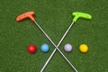 Crossing Mini Golf Putters with Four Balls Royalty Free Stock Photo