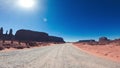 Crossing Mounument Valley in summer season, view from the front of the car