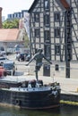 Crossing the river - a balancing sculpture suspended on a rope over the Brda River. Historic 18th-century granaries, Bydgoszcz,