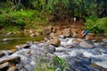 Crossing a small tropical river or stream Royalty Free Stock Photo