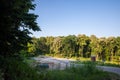 Crossroad between two serbian roads in the forest of Fruska Gora, surrounded by a forest of trees, in summer.