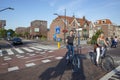 Crossroads in the central part of Delft. Pedestrians and cyclists on the road.