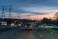 Crossroads of power lines along the highway on a cloudy winter evening