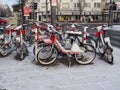 Crossroads with rental bikes on the parking station with snow