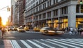 Crosstown traffic speeding through Midtown Manhattan past the busy crowds of people on 23rd Street in New York City Royalty Free Stock Photo