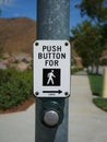 Crosswalk button and sign on street pole. Royalty Free Stock Photo