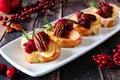 Crostini appetizers with apples, cranberries and brie, close up on plate Royalty Free Stock Photo