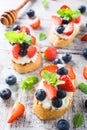 Crostini with grilled baguette, cream cheese and berries