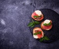 Crostini with salmon, mozarella, tomato and basil Royalty Free Stock Photo