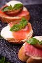 Crostini with salmon, mozarella, tomato and basil Royalty Free Stock Photo