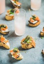 Crostini with smoked salmon and grapefruit cocktails, selective focus