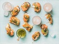 Crostini with smoked salmon and pink grapefruit cocktails, flat-lay