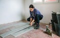 Female bricklayer placing tiles to install a floor