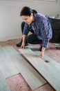 Female bricklayer placing tiles to install a floor