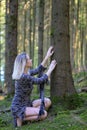 Barefoot blond woman in tatters feeling tree trunk Royalty Free Stock Photo