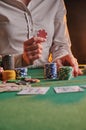 Croupier raises bets with chips. casino, playing at night, gaming business. victory and success, big money. vertical shot Royalty Free Stock Photo