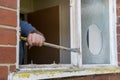 Crowbar being used to remove an old wooden window frame Royalty Free Stock Photo