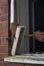 Crowbar being used to remove an old wooden window frame Royalty Free Stock Photo