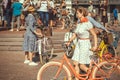 Crowd of active people with cycles in bright vintage clothing at cosplay festival in Europe