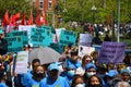 Crowd of activists with signs and flags during May Day Parade at Washington Square Park in NYC